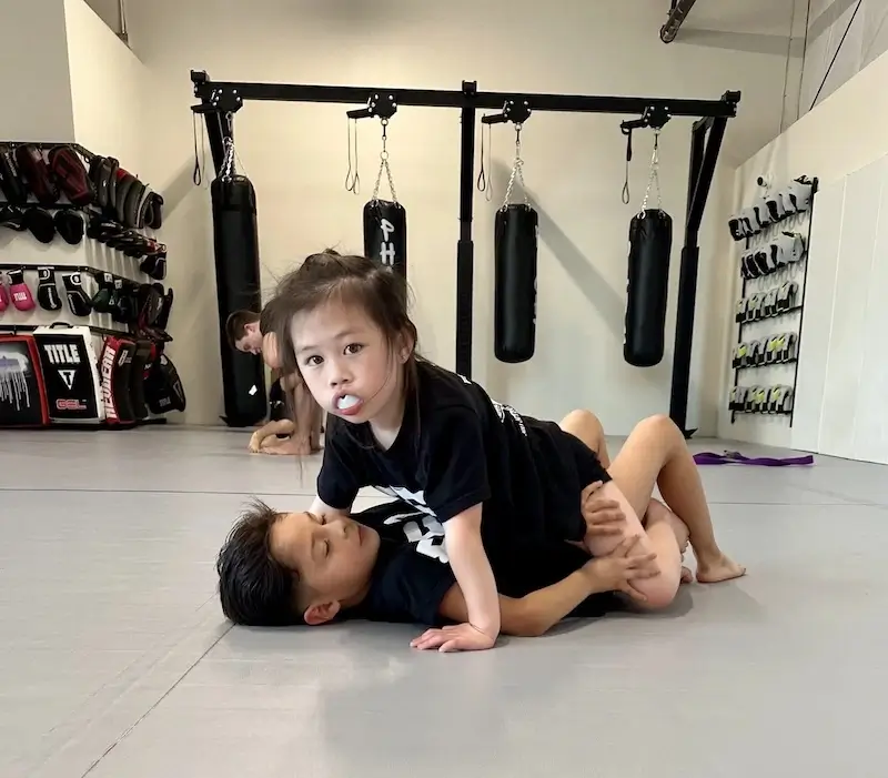 Kids practicing Brazilian Jiu-Jitsu during class.