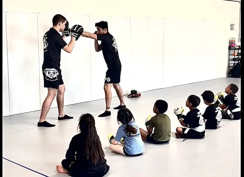 Children training martial arts with a partner.