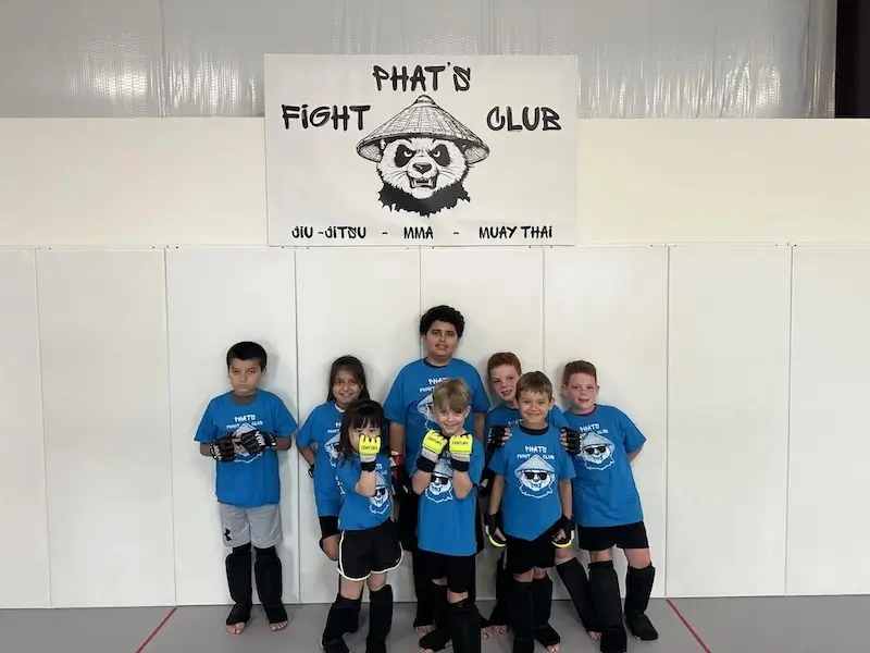 Kids practicing Brazilian Jiu-Jitsu techniques with a partner